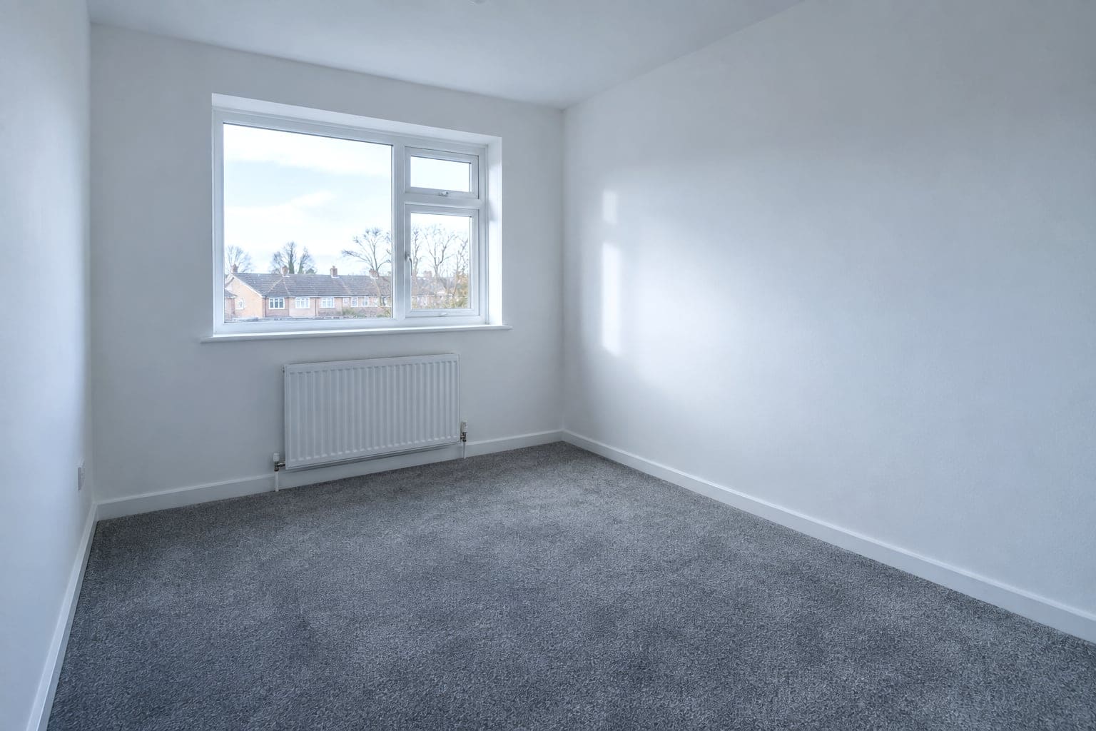 Empty council flat bedroom returned to re-let standard with new carpet and window